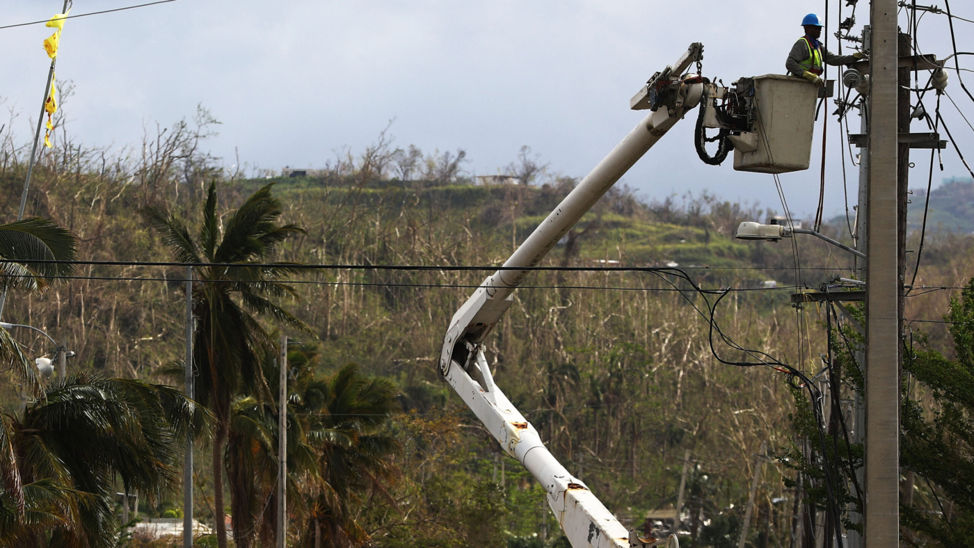 SAN ISIDRO, PUERTO RICO - OCTOBER 05:  A worker repairs power lines about two weeks after Hurricane Maria swept through the island on October 5, 2017 in San Isidro, Puerto Rico. Puerto Rico experienced widespread damage including most of the electrical, gas and water grid as well as agriculture after Hurricane Maria, a category 4 hurricane, swept through.  (Photo by Mario Tama/Getty Images)