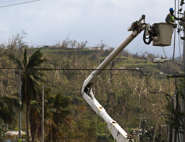 SAN ISIDRO, PUERTO RICO - OCTOBER 05:  A worker repairs power lines about two weeks after Hurricane Maria swept through the island on October 5, 2017 in San Isidro, Puerto Rico. Puerto Rico experienced widespread damage including most of the electrical, gas and water grid as well as agriculture after Hurricane Maria, a category 4 hurricane, swept through.  (Photo by Mario Tama/Getty Images)